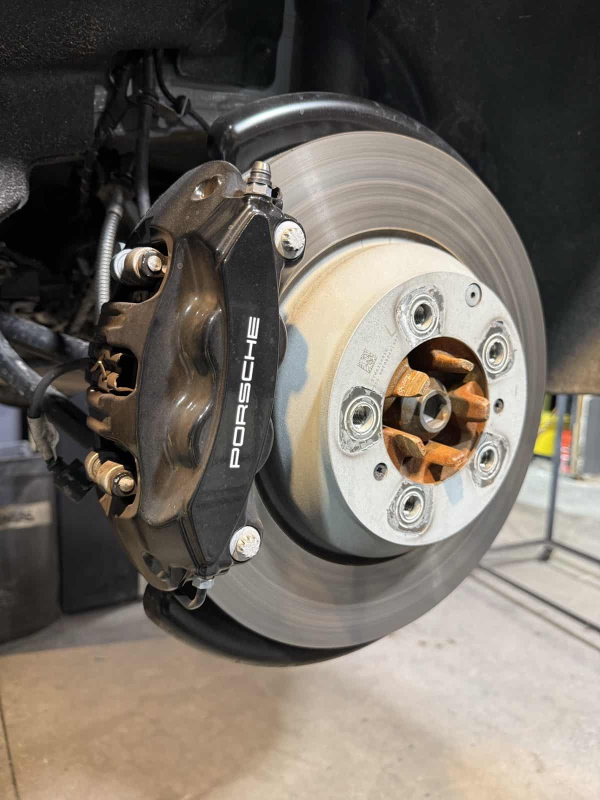 Porsche brake caliper before powder coating - side view by ColorWerks Denver