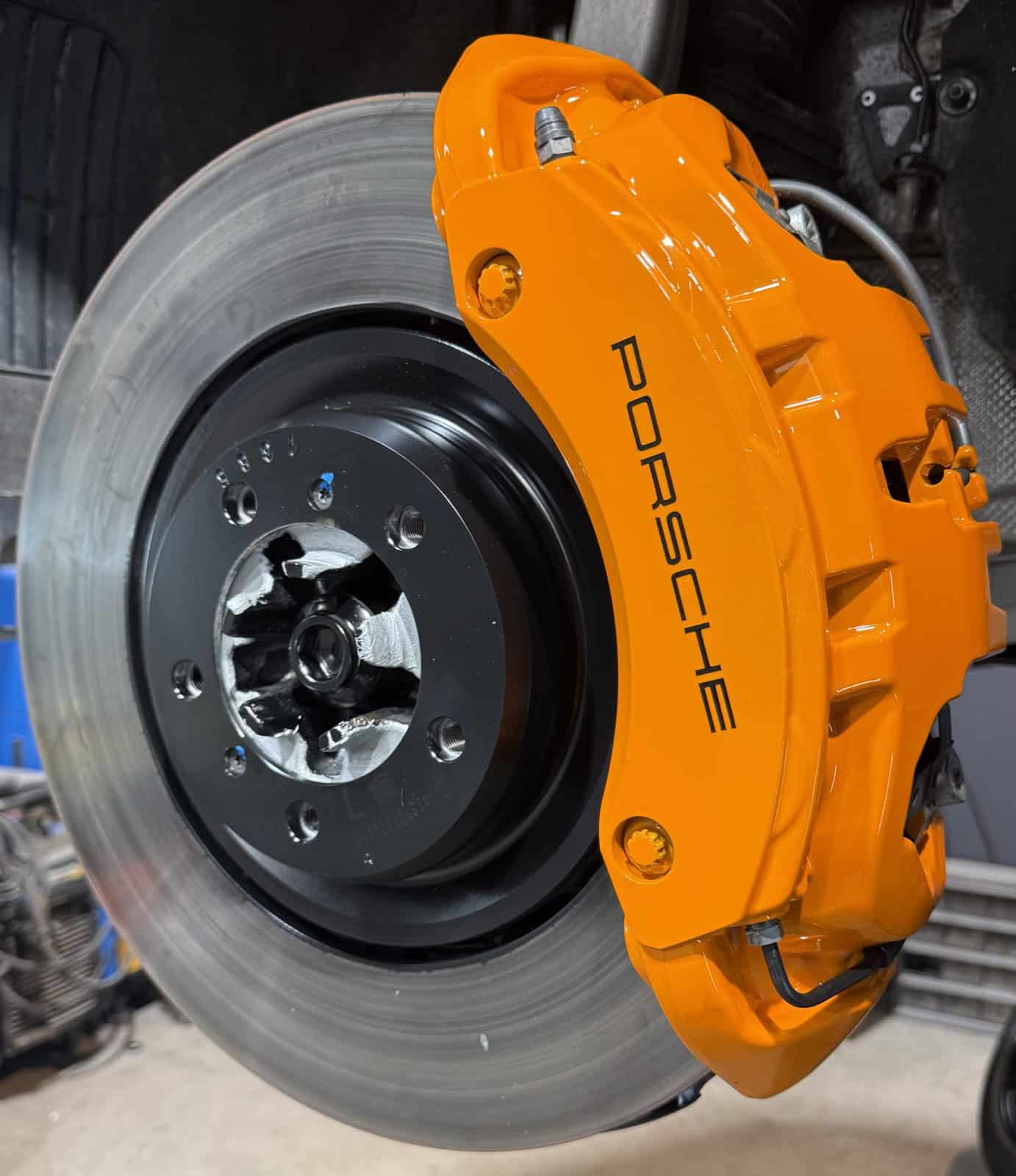 Porsche brake caliper powder coated orange by ColorWerks Denver