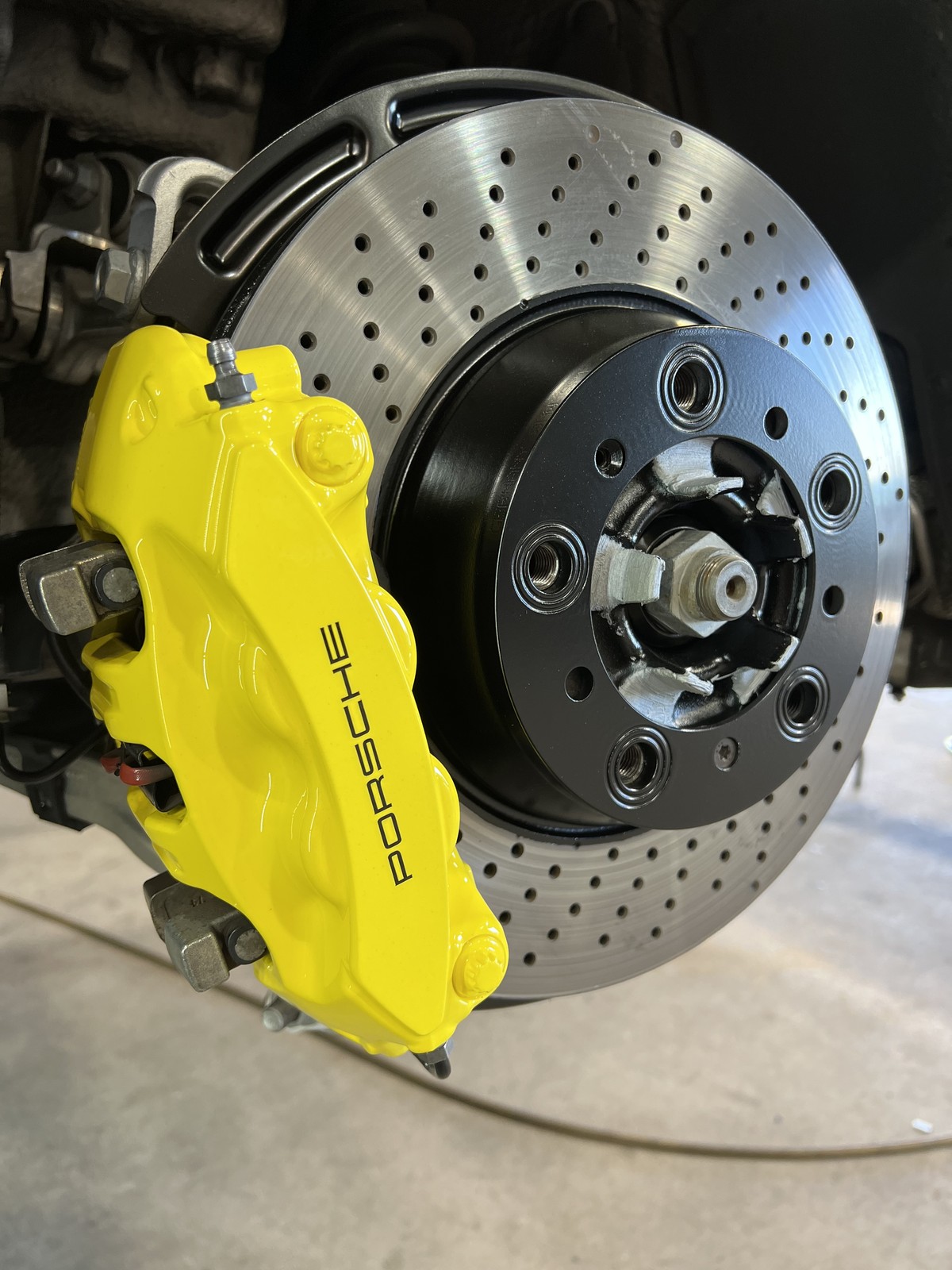 Porsche caliper after yellow powder coating drilled rotor