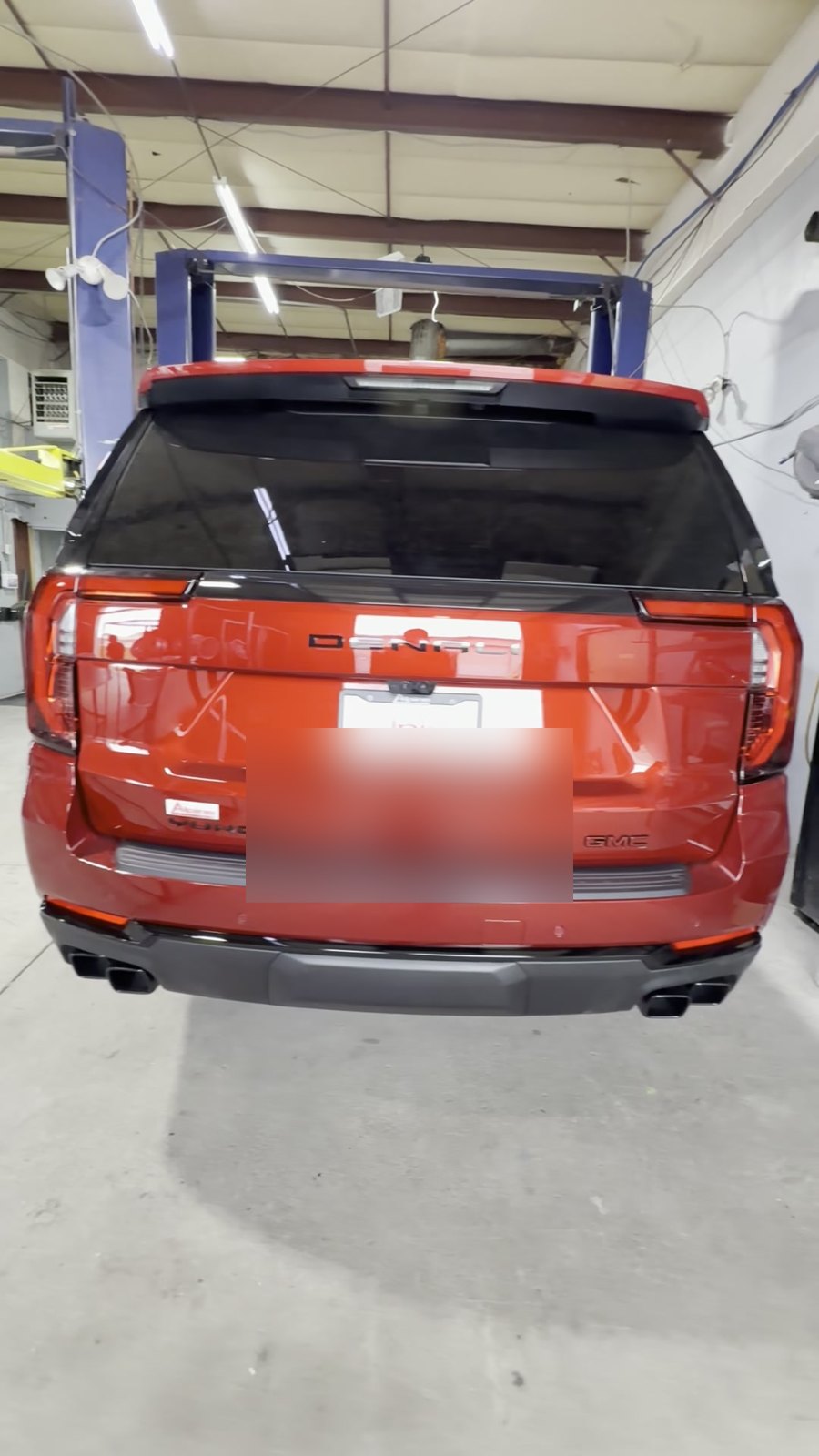 AFTER: Red GMC Sierra AT4 rear badges blacked out, Denver