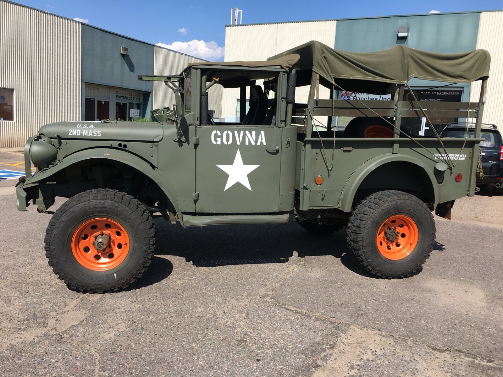 Orange powder coated wheels on a Dodge M37