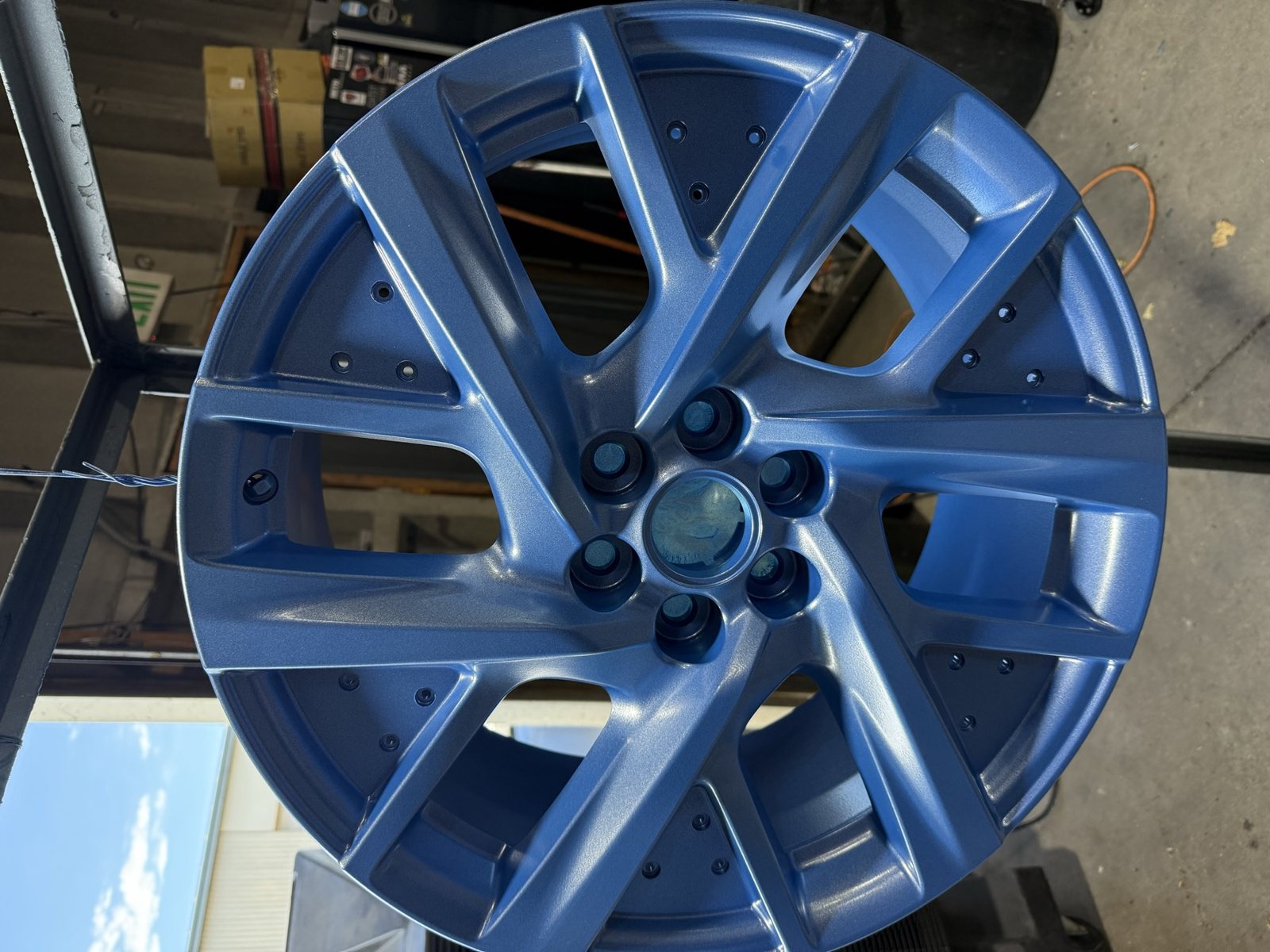 Metallic blue powder coated wheel