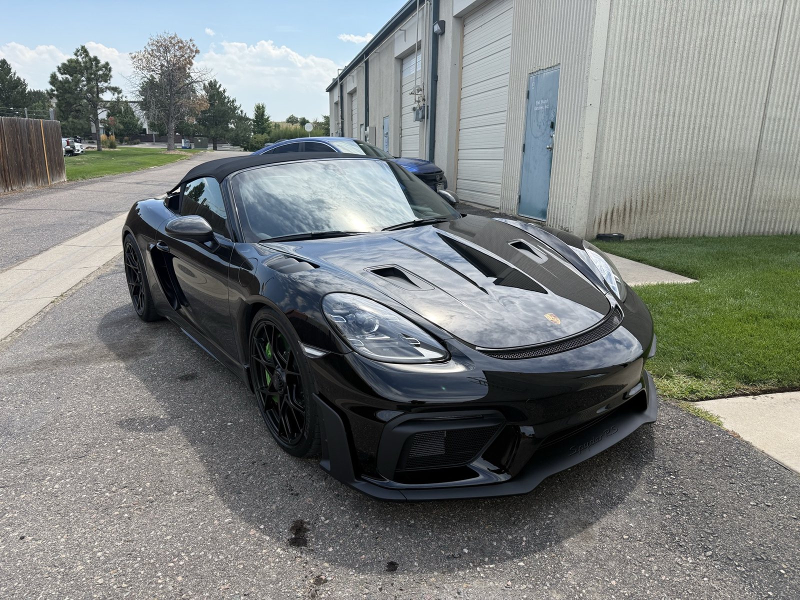 Gloss black wheels on a Porsche 718 Spyder RS, powder coated in Denver
