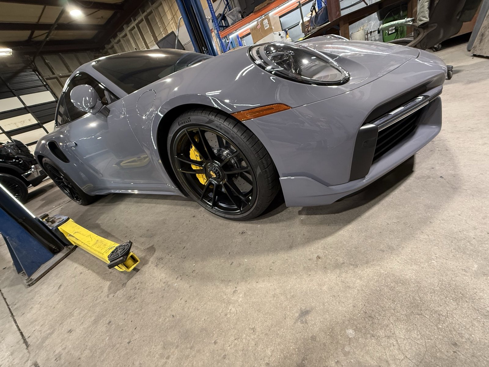 Gloss black wheels with yellow calipers on a Porsche 911