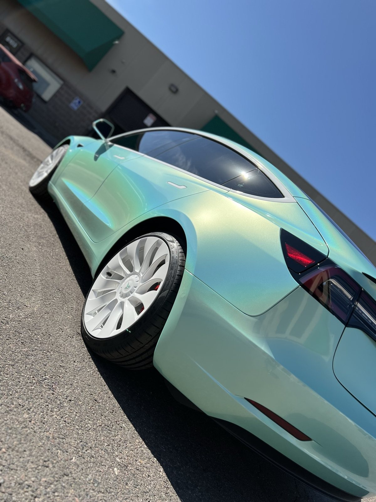 Chameleon green-blue powder coated wheels on a Tesla Model 3