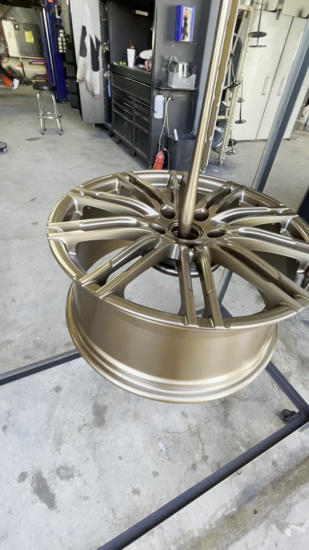Bronze powder coated wheel on a stand after curing