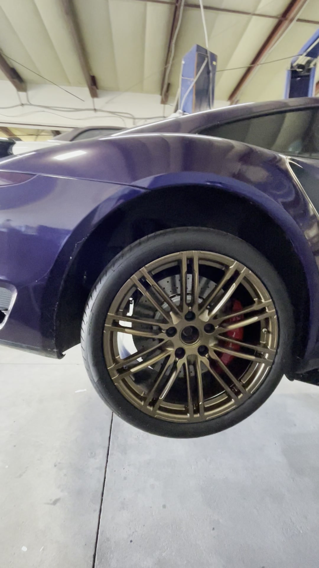 Bronze powder coated wheels with red brake calipers on a purple car