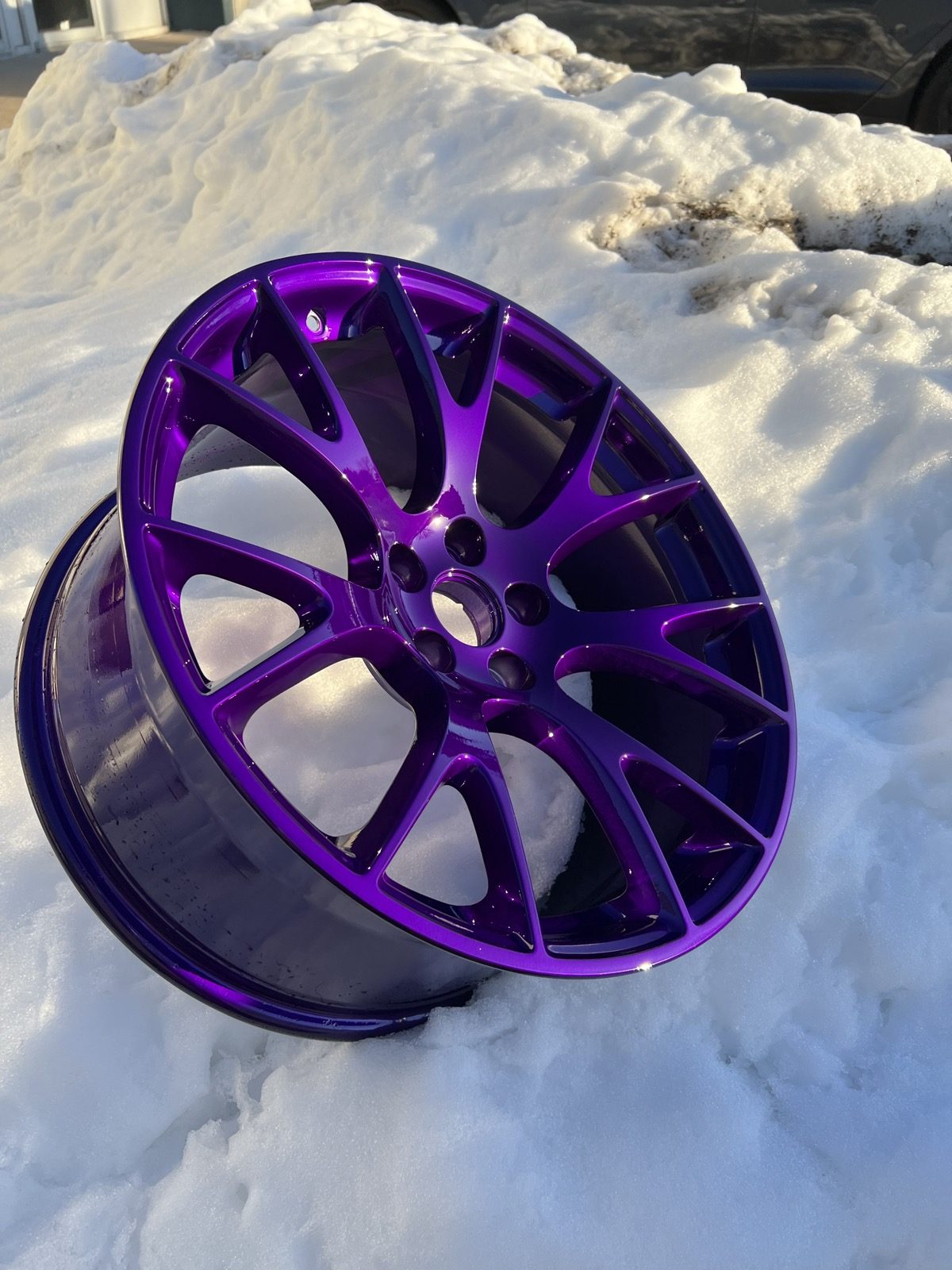 Gloss purple powder coated wheel photographed outside the shop in the snow