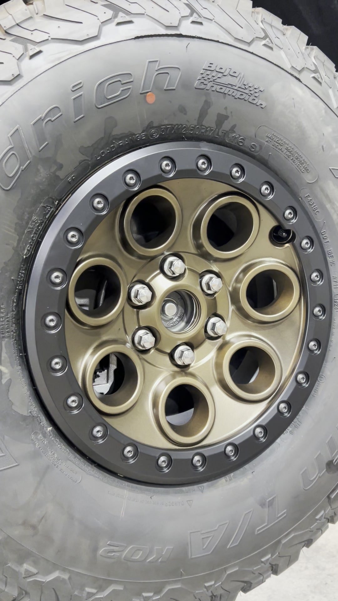 Bronze off-road wheel with black outer ring on a BFGoodrich tire