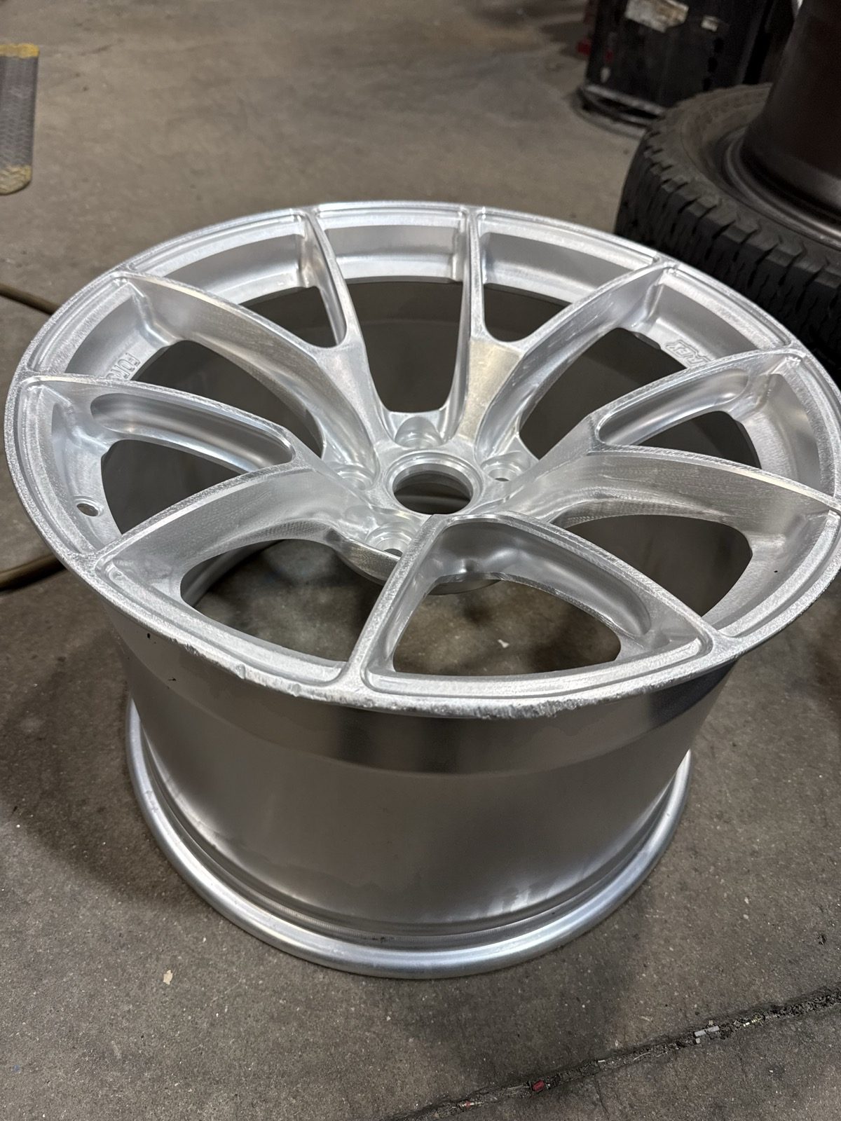 Forged aluminum wheel stripped to bare metal and prepped, waiting to be powder coated