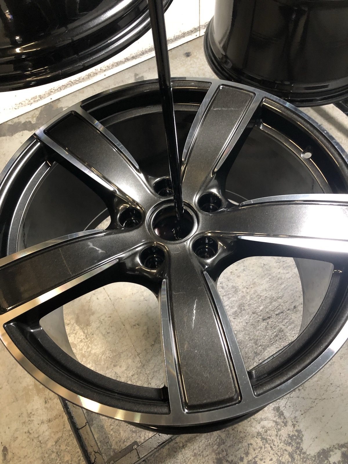 Two-tone wheel with a metallic charcoal finish and machined face, gloss black inner